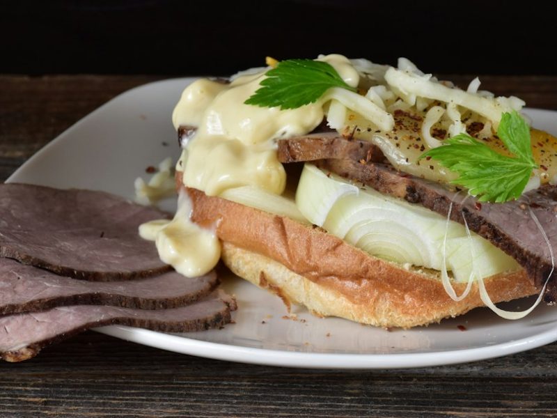 A sandwich piled with thin-sliced meat
