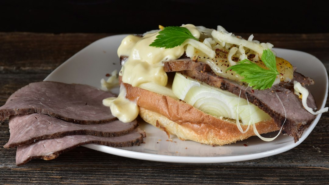 A sandwich piled with thin-sliced meat